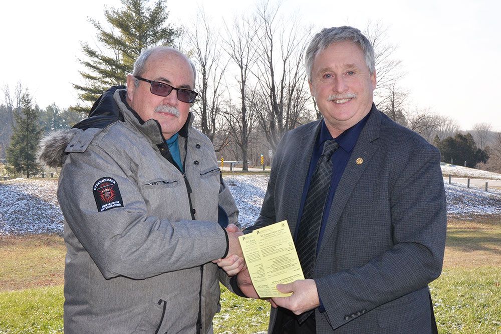 Dinner Committee Chair Dave Frayne sells first tickets to South Huron Mayor George Finch.