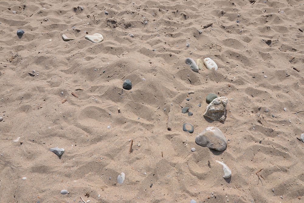 A file photo of sand by shoreline along Lake Huron.