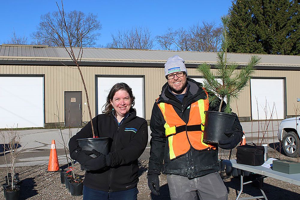 Upper Thames River Conservation staff with trees.